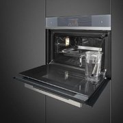 Компактный духовой шкаф с пароваркой Smeg SF4104WVCPS фото 2 в Санкт-Петербурге